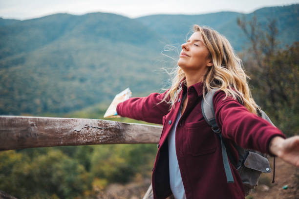 Young woman breathing pure air in a forest.