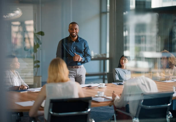 istock Man, meeting and discussion with office, boardroom and collaboration or workshop. Leader, training and business presentation for mentor, coaching and strategy for teamwork and planning with startup 2148861853