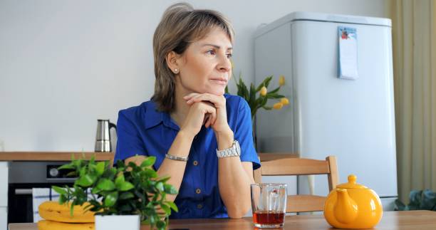 istock Gen X woman savoring tea, morning ritual at home. Morning routine, serene kitchen setting, Gen X tranquility. Morning ritual embodied, tranquil start, generation X serenity. Woman morning concept. 2148861977