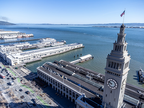 Aerial view of San Francisco ferry building during springtime day with the bay in background