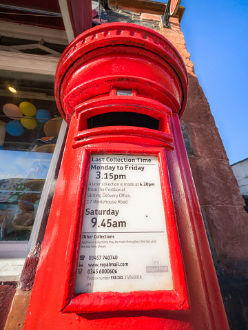 Aberfoyle, Scotland - Close up showing collection times and other information for a Royal Mail post box outside Aberfoyle's Post Office.