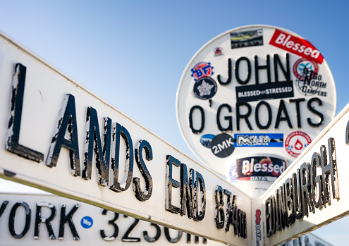 John O'Groats, Scotland - Stickers covering a sign at John O'Groats with distances to famous destinations, including Lands End, famously at the other end of Britain.