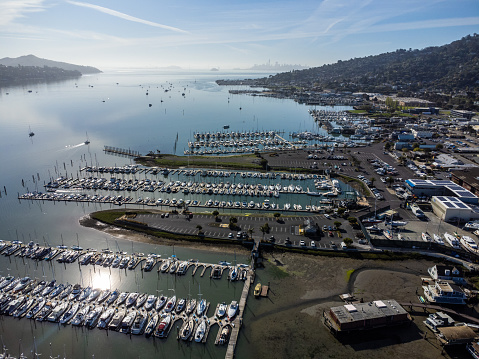Aerial view of boats in Sausalito, California, during low tide and springtime day.