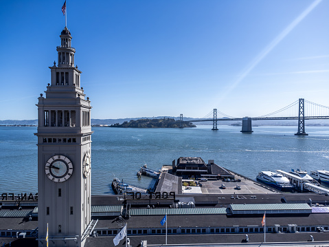 Aerial view of San Francisco ferry building during springtime day with the bay in background