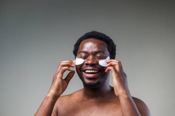istock Young man using skin care product - under eye patches 2148865303