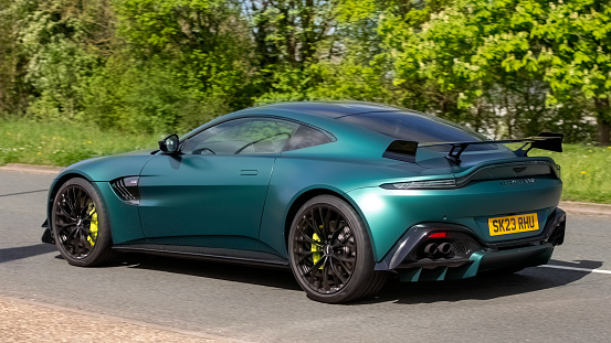 Milton Keynes,UK- Apr 14th 2024: 2023 green Aston Martin Vantage F1 edition car  travelling   on a British road