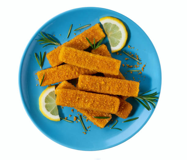 istock Crispy golden fried fish fingers sticks on a blue plate isolated on white background. Top iew. 2148866421