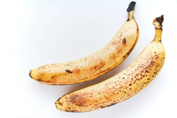 Overripe bananas on a white background. Ripe yellow fruit.