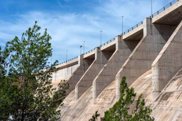 istock Side and bottom view of a dry concrete river dam with trees next to it 2148867807