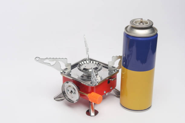 Portable camping gas burner with a gas cylinder on white background