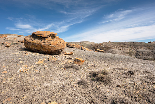 Large round red concretion on the horizon at Red Rock Coulee near Seven Persons, Alberta, Canada