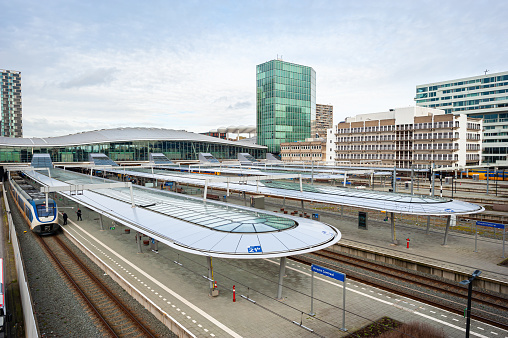Railway track system of the Munich city main terminal station with 32 platforms. At the background you can see the silhouette of the Frauenkirche (Cathedral of Our Dear Lady).