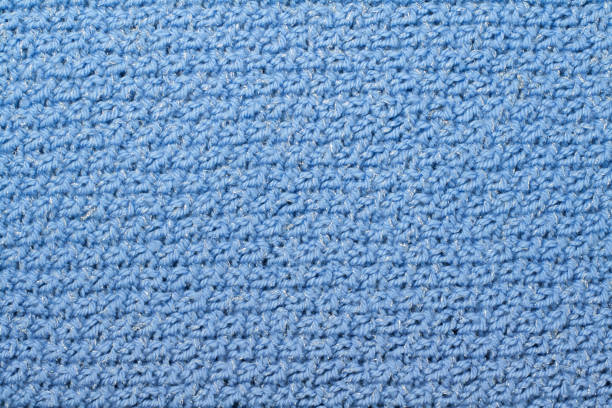 istock Sweater or scarf fabric texture large knitting. Knitted jersey background with a relief pattern. Braids in knitting . Wool hand- machine, handmade, blue. 2148870810