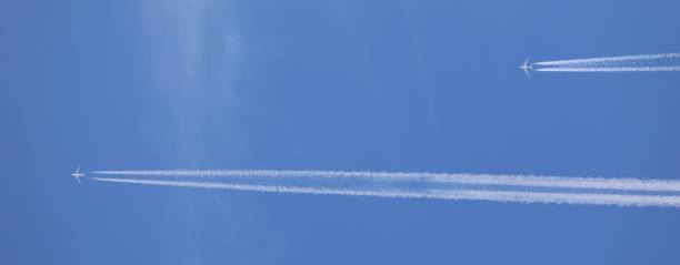 istock two double airplane tracks in the blue sky 2148870998