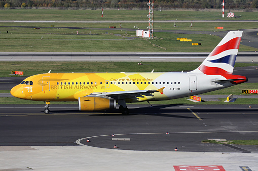 Dusseldorf, Germany - October 27, 2012: British Airways Airbus A319-100 with registration G-EUPC in special Olympic Flame livery on taxiway at Dusseldorf Airport