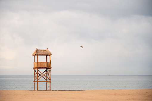Paradisiacal and lonely Moroccan beach with a watchtower, seagull and boat in one morning. Copy Space. Travel