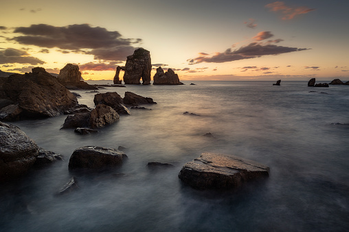 View of the Cantabrian coast at sunset in San Juan de Gaztelugatxe, Bermeo, Bizkaia, with the tide between the rock formations