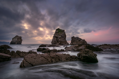 View of the Cantabrian coast at sunset in San Juan de Gaztelugatxe, Bermeo, Bizkaia, with the tide between the rock formations