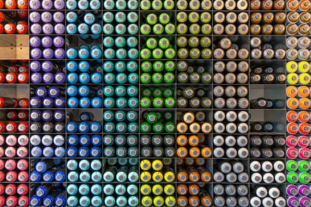Spray paint aerosol cans organized colors stacked.