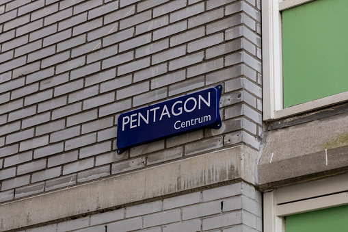 Amsterdam, the Netherlands. 23 March 2024. Pentagon centrum Amsterdam street sign nameplate on a brick wall.