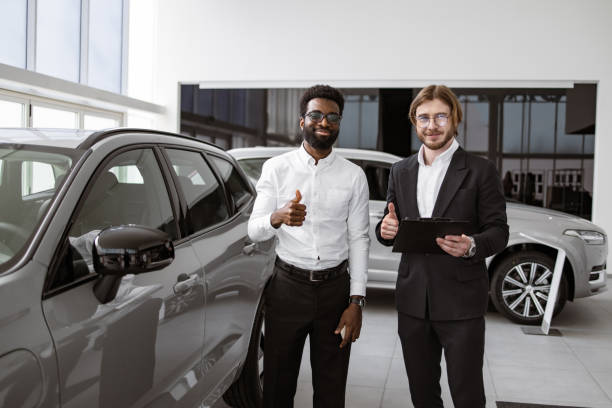 istock Consultant provides all information about new car using clipboard to male client 2148876408