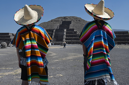 Tourists wearing sombraros in front of the Pyramid of teh Moon near Mexico City at Teotihuacan