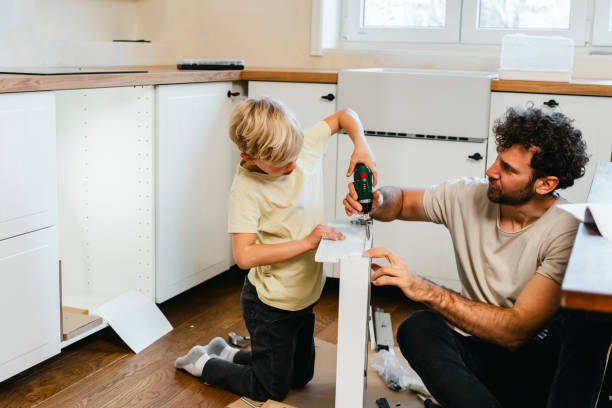 istock Father and son assembling kitchen furniture 2148879292