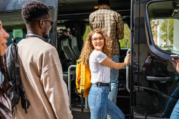 istock Group of students boarding a bus 2148879434