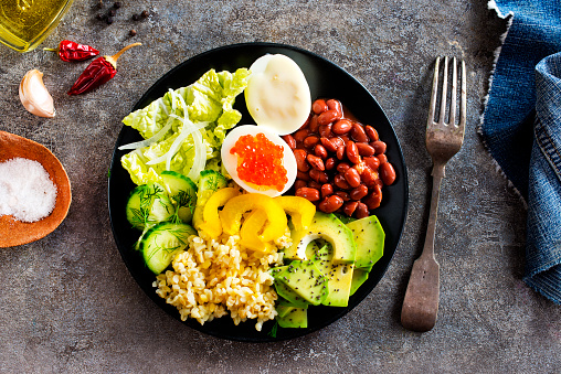 Buddha bowl, balanced food, vegetarian menu. Eggs, avocado, salad lettuce, bulgur