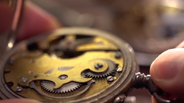 Watchmaker holds the vintage pocket watch. Mechanical watch repair