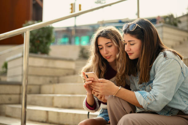 istock Two girls sitting on a staircase 2148883512