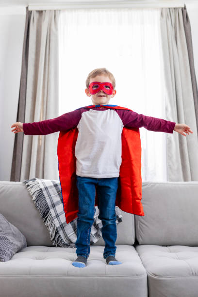 istock Young Boy in Superhero Costume on Couch 2148884427