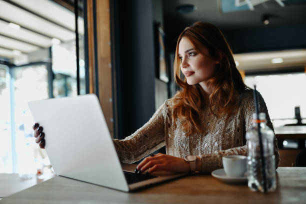 istock Beautiful Female Looking Outside For Inspiration While Using Laptop For Graphics Design Project 2148884828