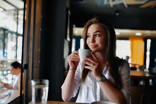 istock Beautiful Female Day Dreaming And Drinking Afternoon Coffee 2148884954
