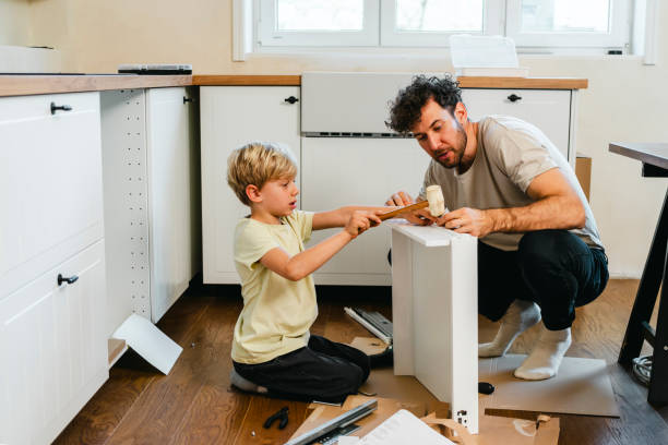 istock Father and son assembling kitchen furniture 2148885081