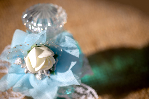 white artificial flower and blue tulle, close-up.