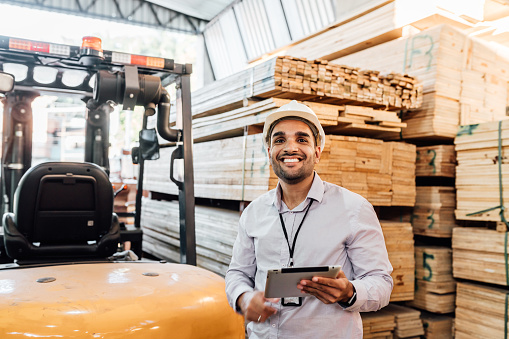 Portrait of a timber warehouse manager holding tablet