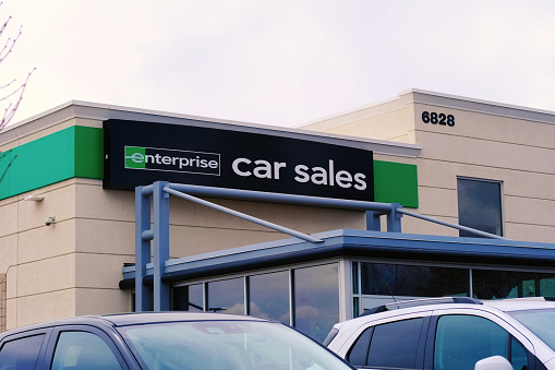 Highlands Ranch, Colorado, USA - April 01 2024: Enterprise Car Sales used cars dealer company sign, dealership center entrance, and parking lot.
