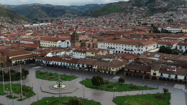 Aerial orbit panorama looking over Plaza de Armas, the city of Cusco and the Peruvian Andes