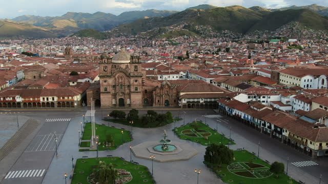 Unparalleled Aerial Orbit of Cusco's Plaza de Armas, Compania de Jesus Church, the City and Andes on Horizon (No People)