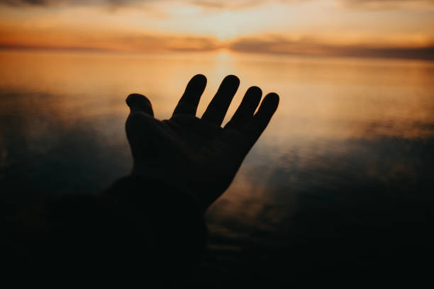 istock Close-up human hand at sunset 2148886797