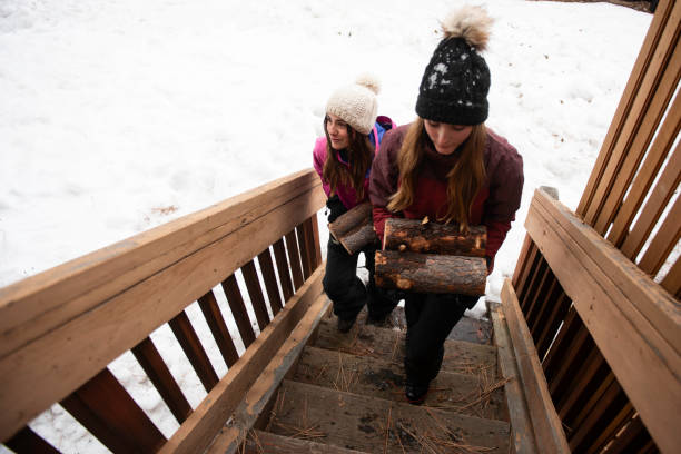 Mom and daughters on a winter snowy vacation  in a mountain cabin