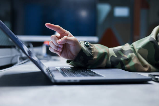 istock close up solider man officer hand point on monitoring program to control about radar or satellite signal at dark operation room in military station for technology and security concept 2148890424