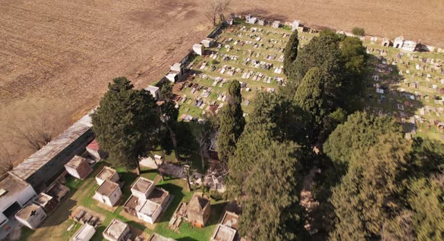 Rural tranquility at a small cemetery nestled among farmlands - aerial