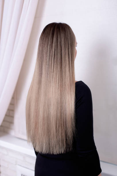 istock Female back with long straight blonde hair 2148892055