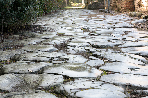 Ancient roman road in Ostia Antica. Rome, Latium, Italy