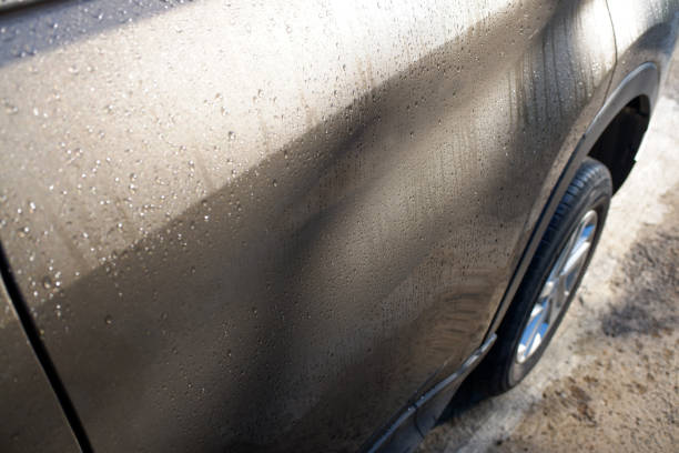 Morning dew on a gray car body