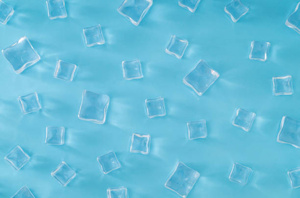 istock Ice cubes pattern on light blue background. Minimal summer drink concept. Trendy summertime pattern backdrop. Flat lay, top of view. 2148894923