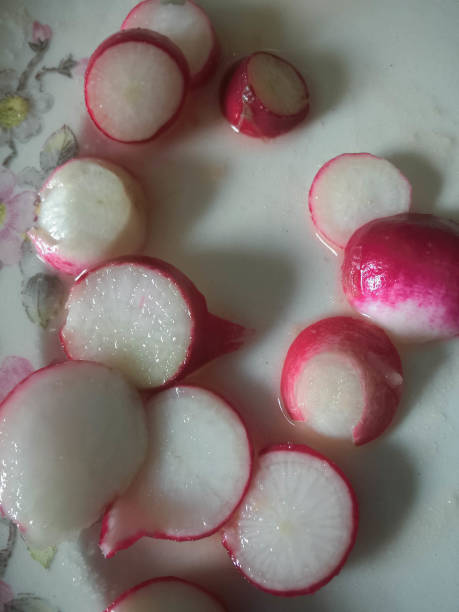 Radishes in a bowl of water, close-up, selective focus stock photo