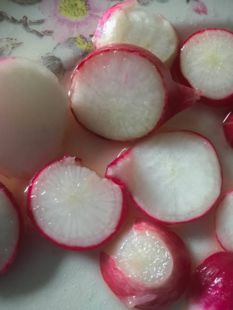 Organic radish cut into circles. Organic farming concept. Radish background. Cooking concept. stock photo